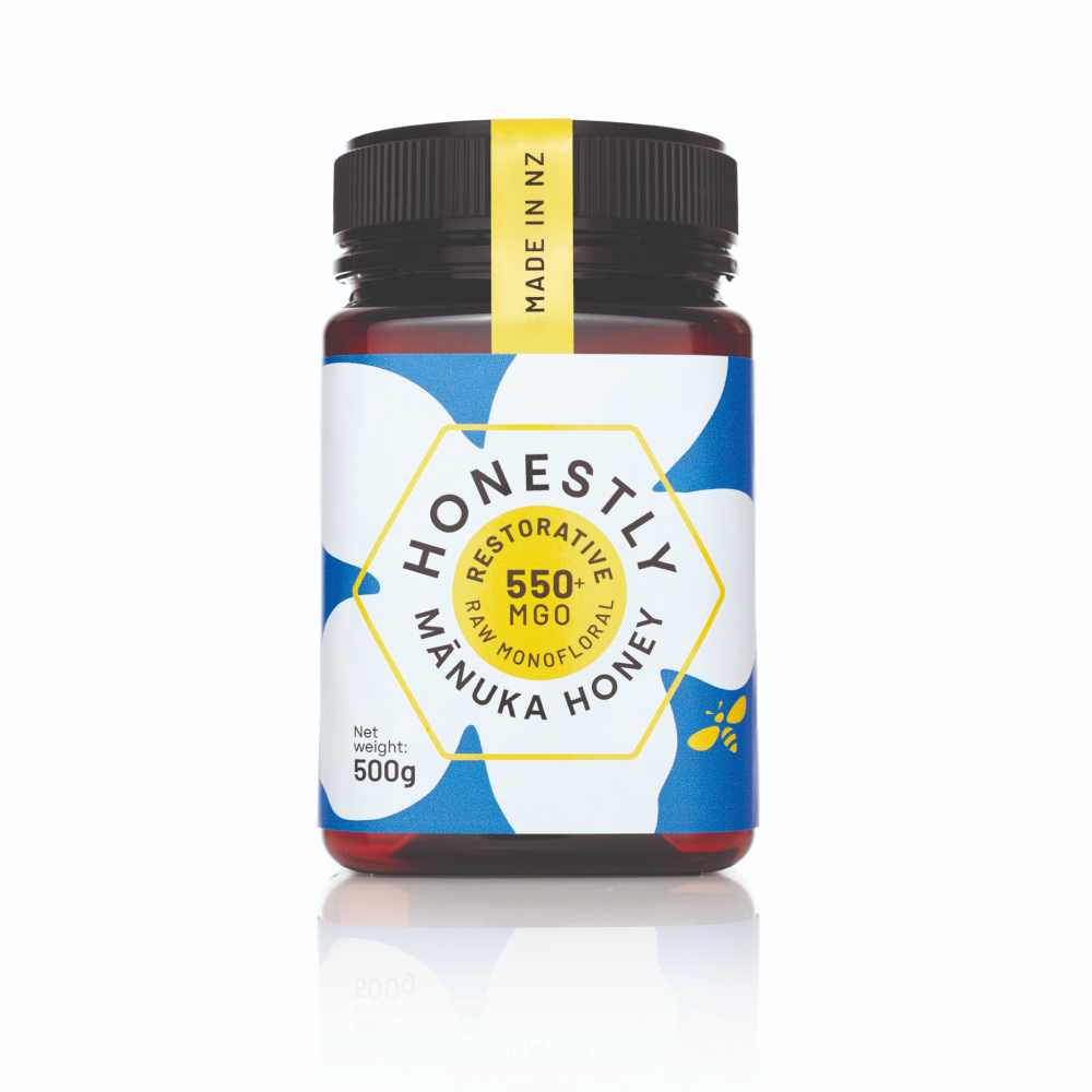550+ MGO Manuka honey jar with a colourful label on a white background